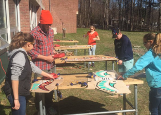 Middle school students working on a project outside